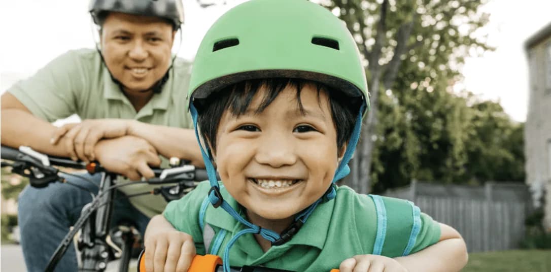 Child cycling with helmet, BikeSpot